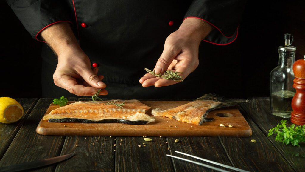 man preparing fish cod for cat.
cats eat cod